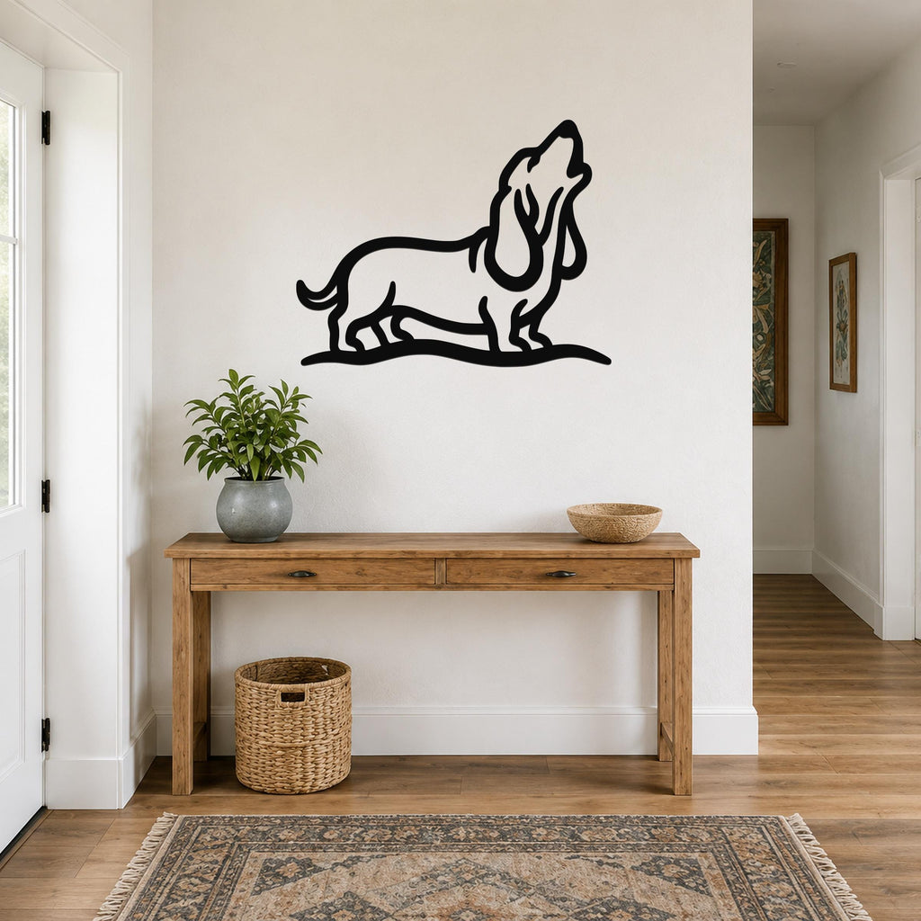 Black metal wall art of a howling basset hound silhouette, mounted above a wooden console table in a hallway.