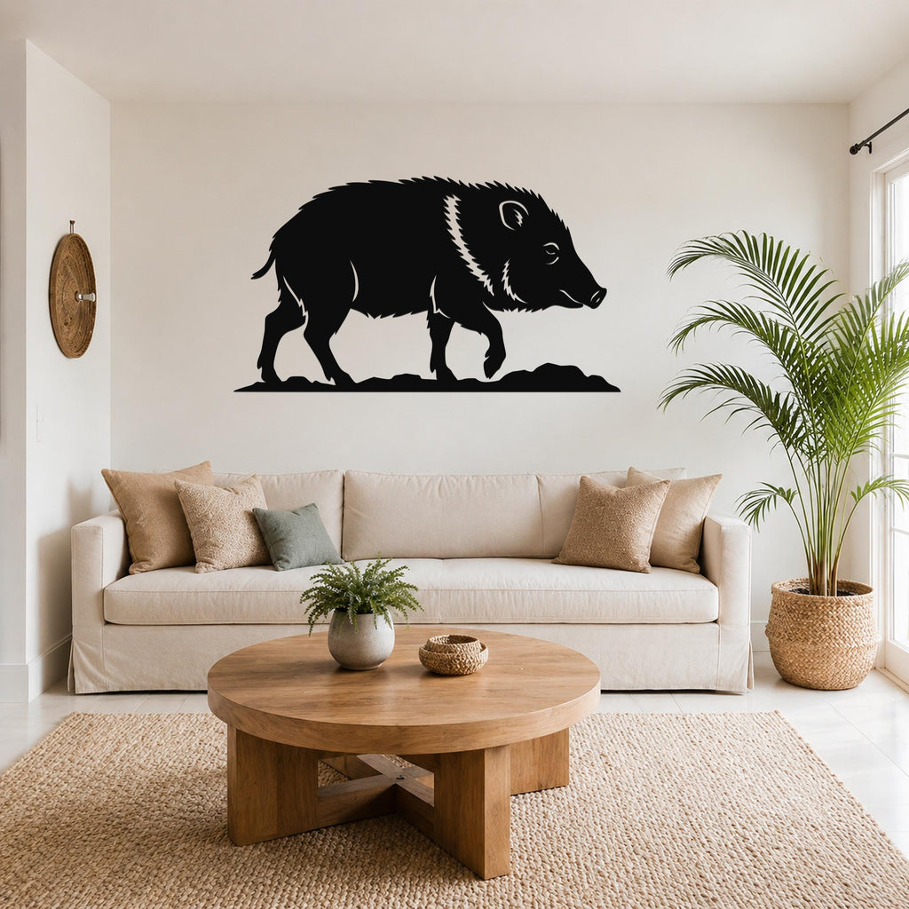 Black metal javelina wall art silhouette with white line detailing, mounted above a beige sofa in a living room.