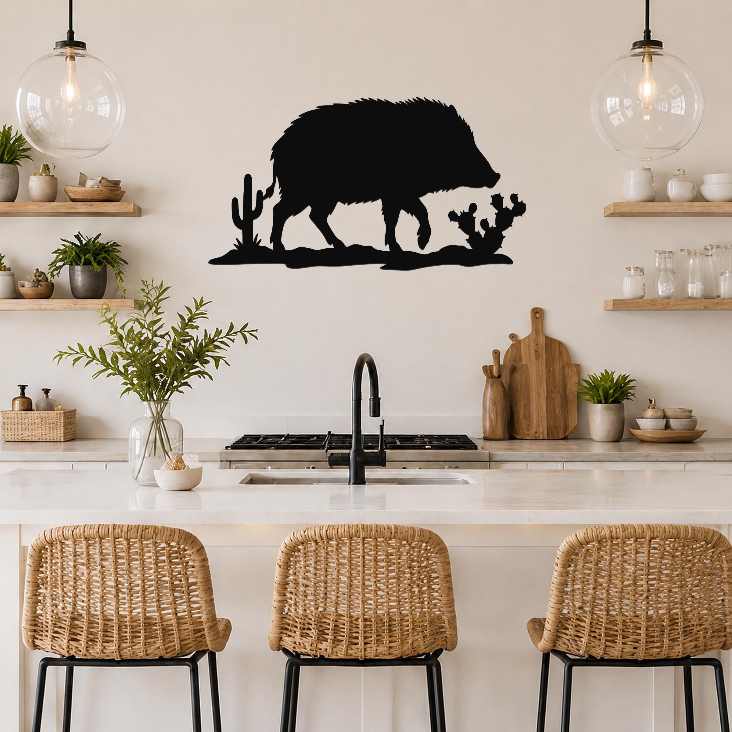 Black metal javelina wall art with cactus cutouts, mounted above a kitchen counter in a modern rustic kitchen.