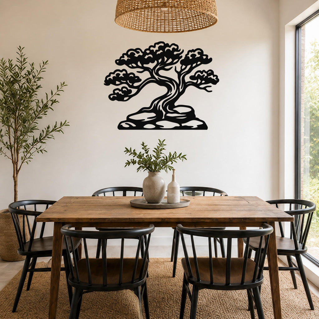 Black metal juniper tree wall art with intricate branch and cloud cutouts, mounted on a dining room wall above a wooden table.