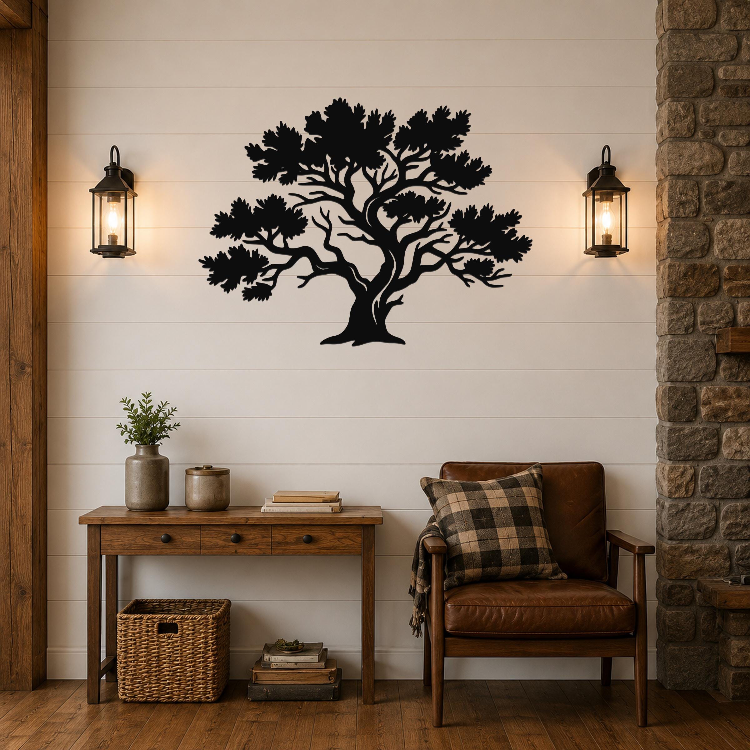 Black metal juniper tree wall art with detailed branch and leaf cutouts, mounted on a shiplap wall above a wooden console table in a living room.