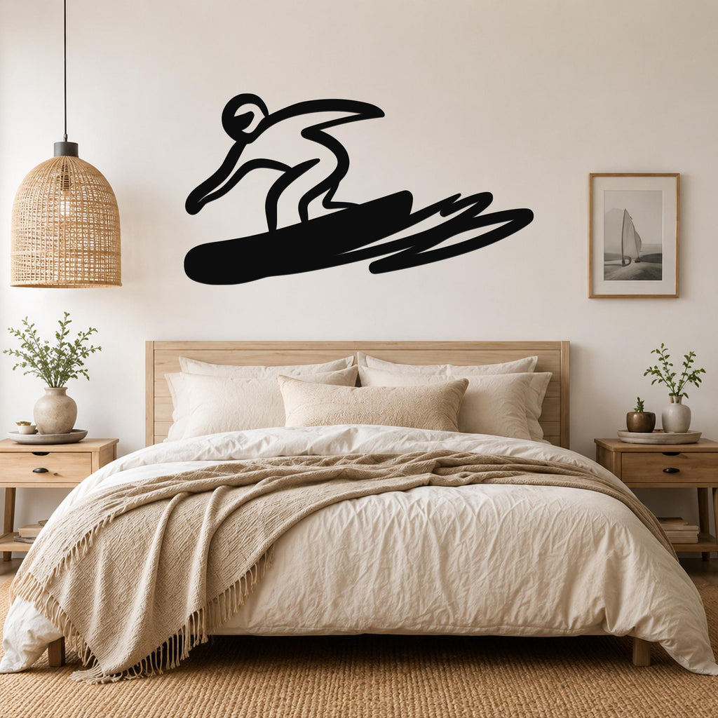 Black metal wall art silhouette of a snowboarder in motion, mounted above a bed in a bedroom.