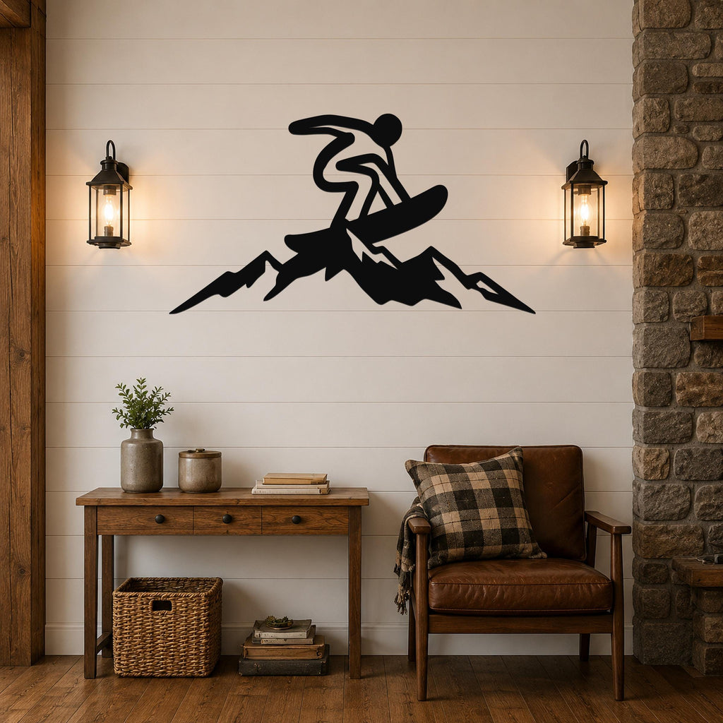 Black metal wall art silhouette of a snowboarder on a mountain, mounted above a wooden console table in a living room.