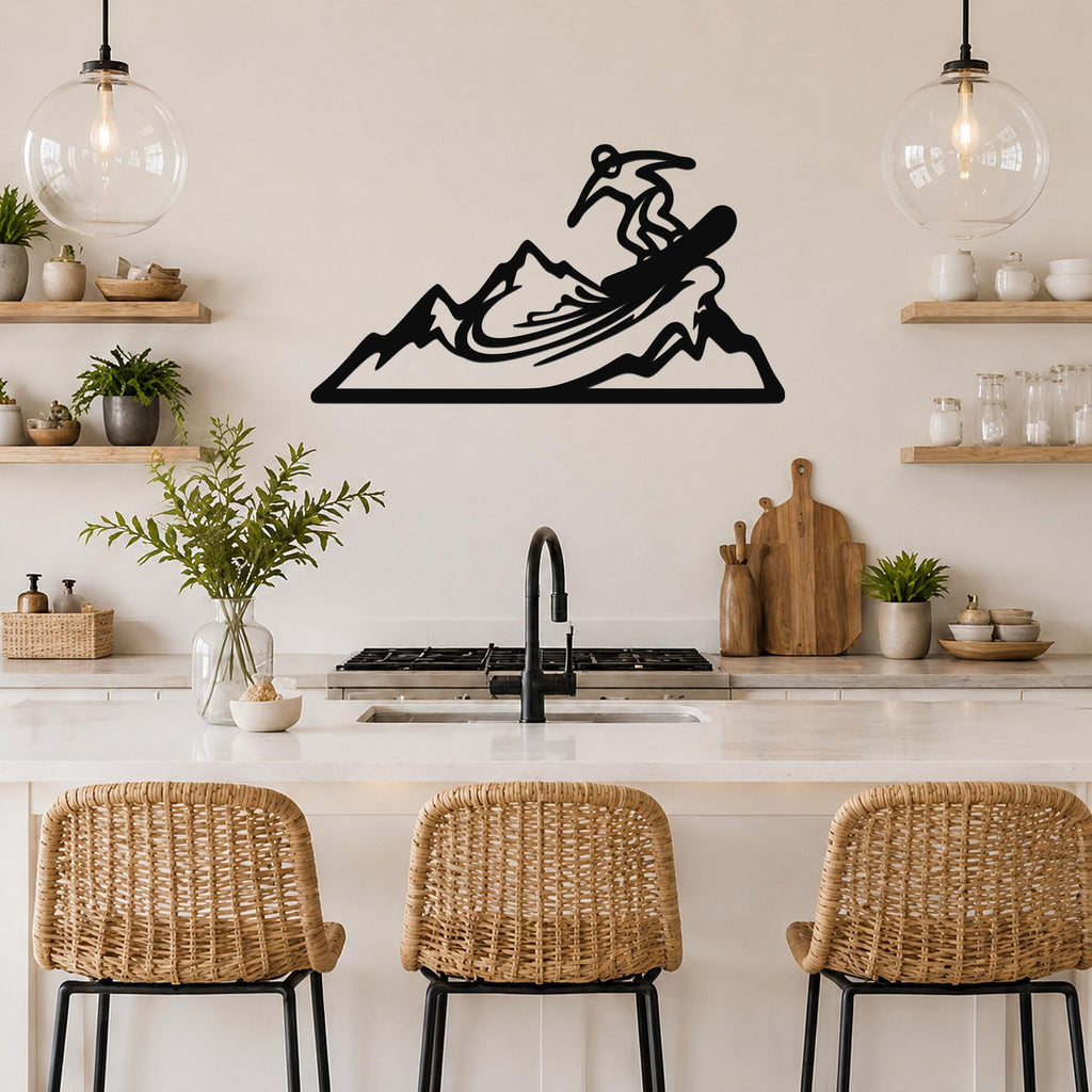 Black metal wall art cutout of a snowboarder on a mountain, mounted above a kitchen counter with wicker bar stools.