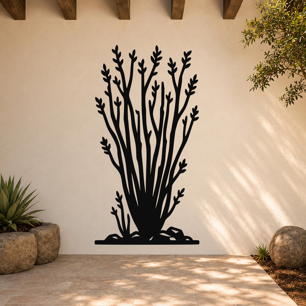Black metal wall art cutout of an ocotillo plant with branching stems and leaf clusters, mounted on a light-colored outdoor wall above a tiled patio.