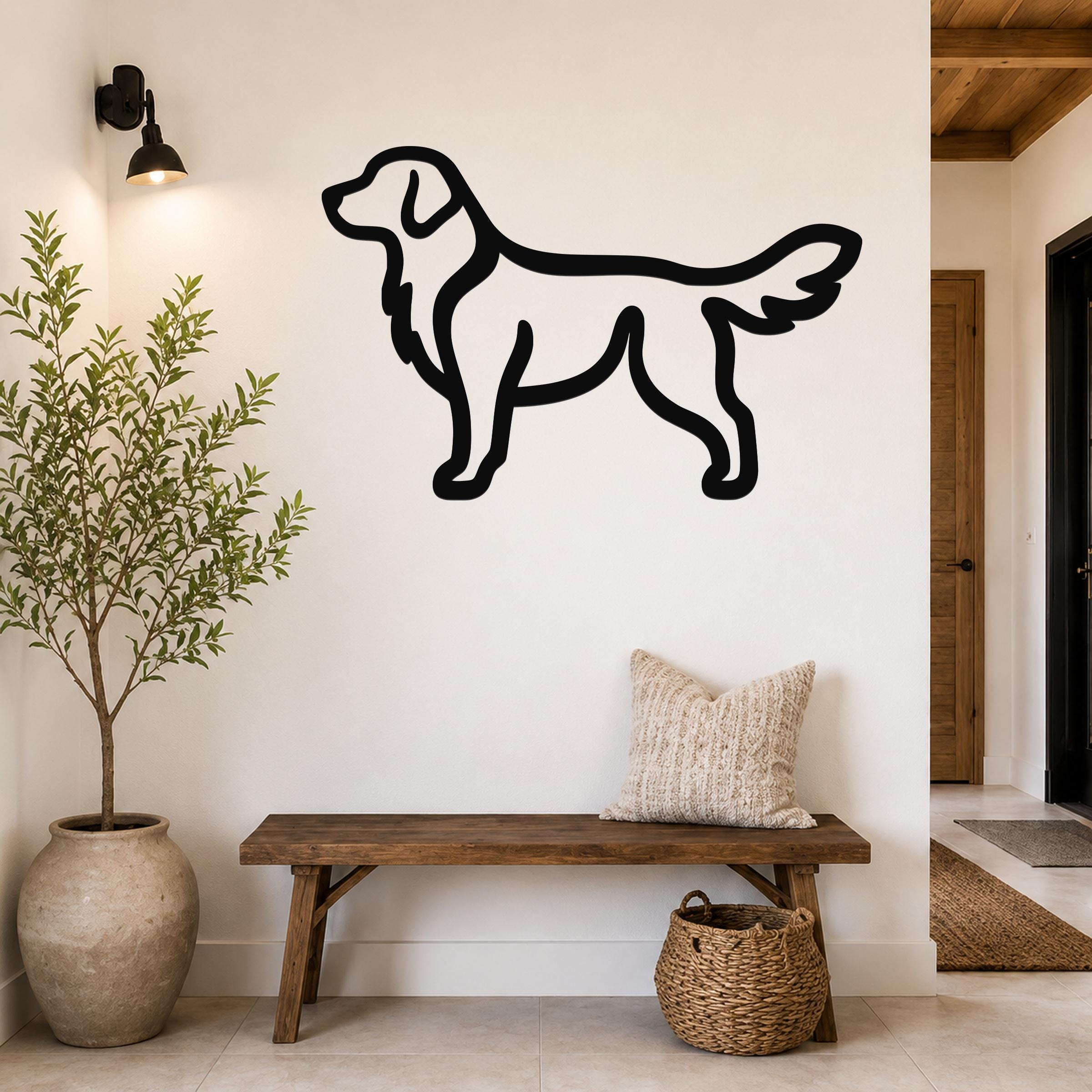 Black metal retriever silhouette wall art mounted on a white wall above a wooden bench in a hallway.
