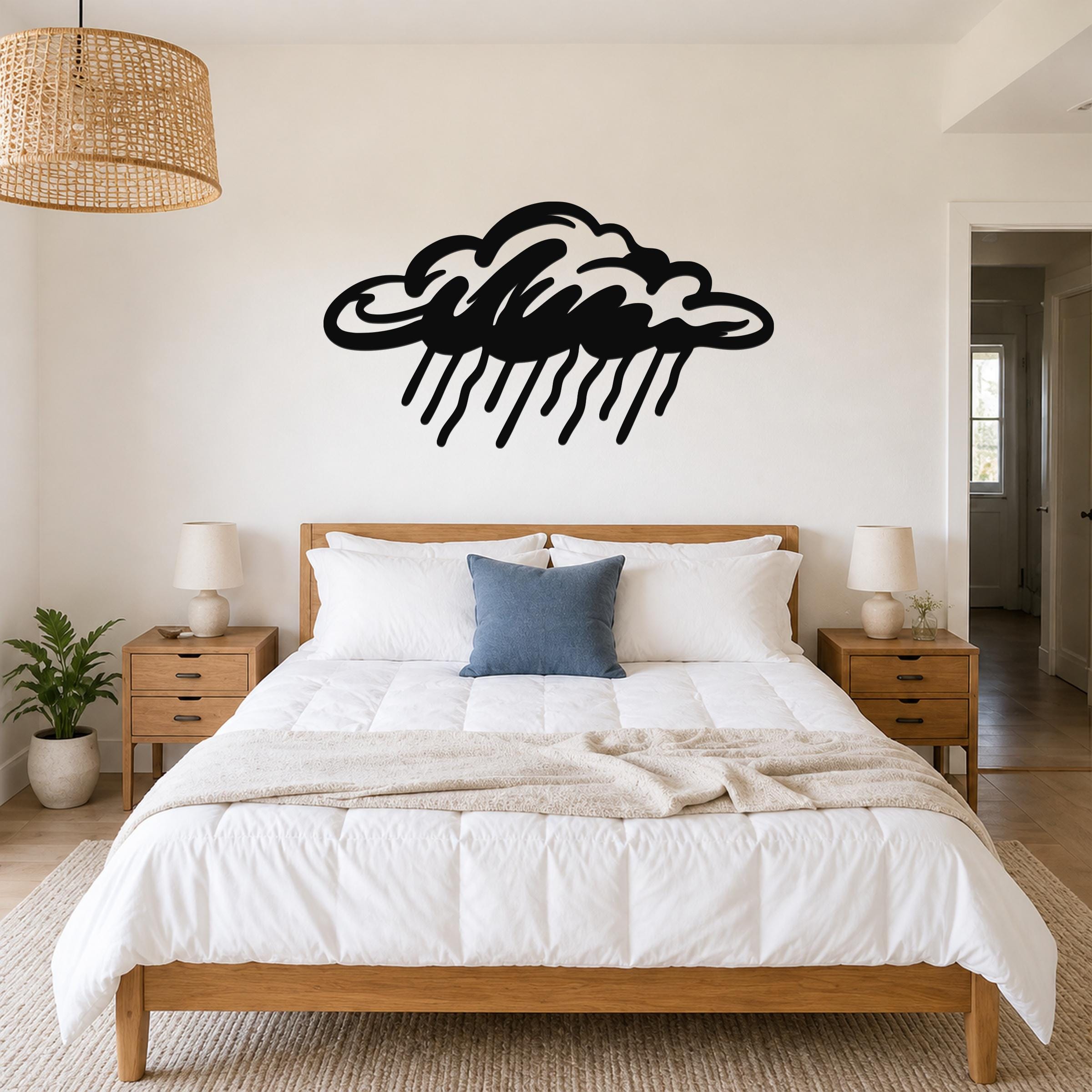 Black metal rain cloud wall art with raindrop cutouts, mounted above a wooden bed in a bedroom.
