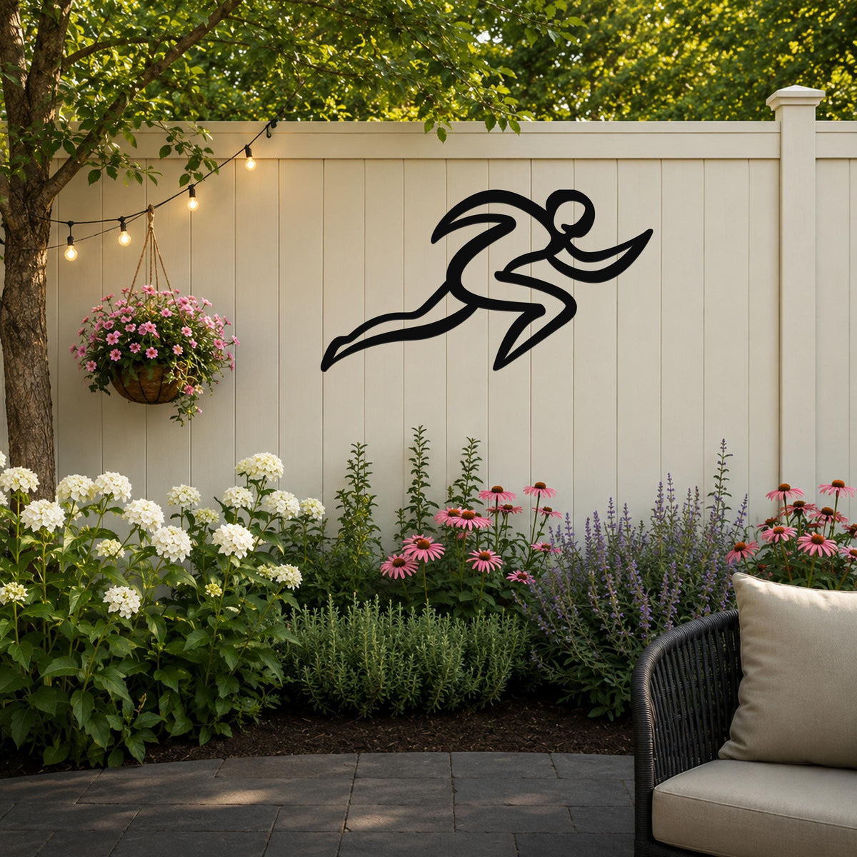 Black metal runner wall art with motion-line cutouts, mounted on a white outdoor fence above a flower bed.