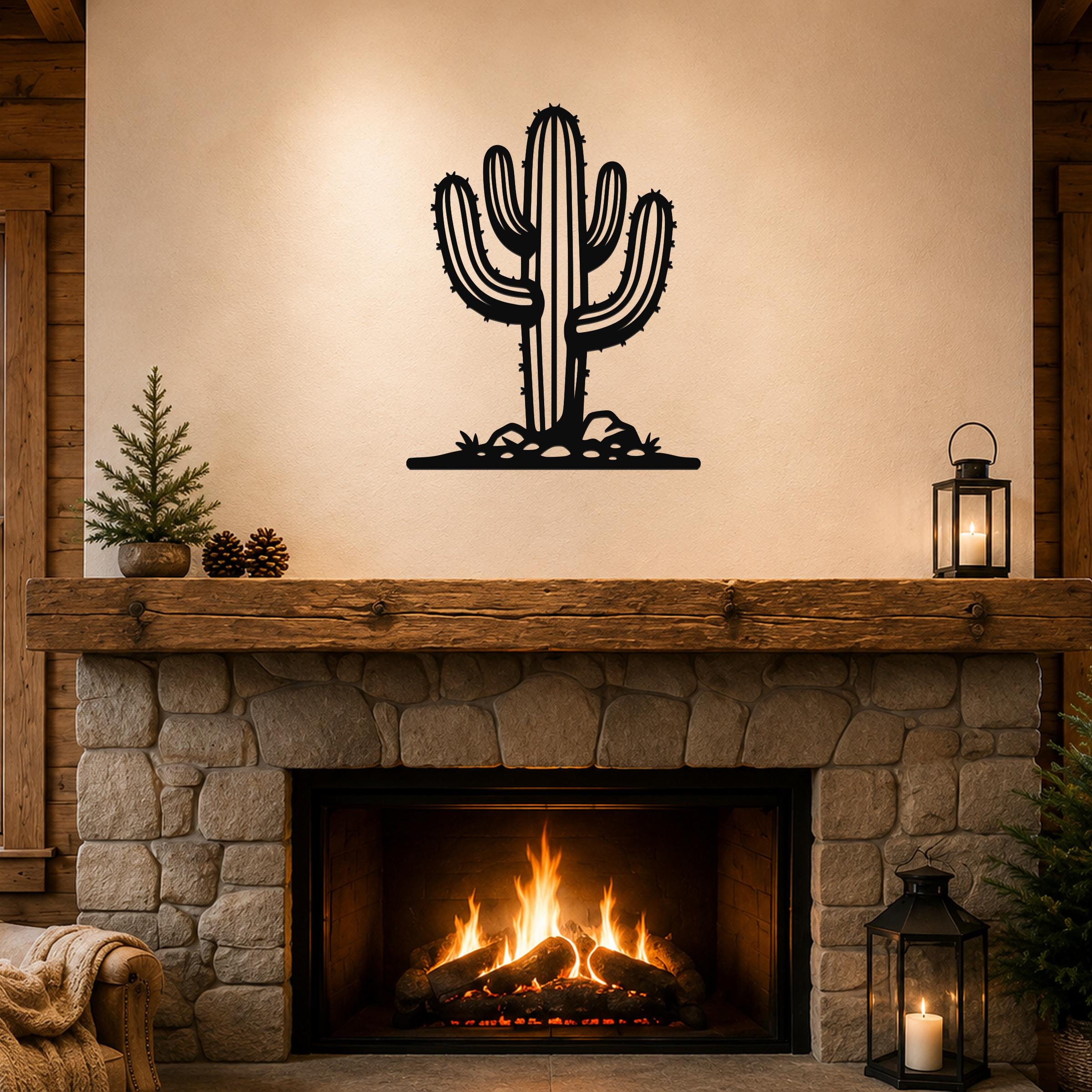 Black metal saguaro cactus wall art with spines and base cutouts, mounted above a stone fireplace in a rustic living room.