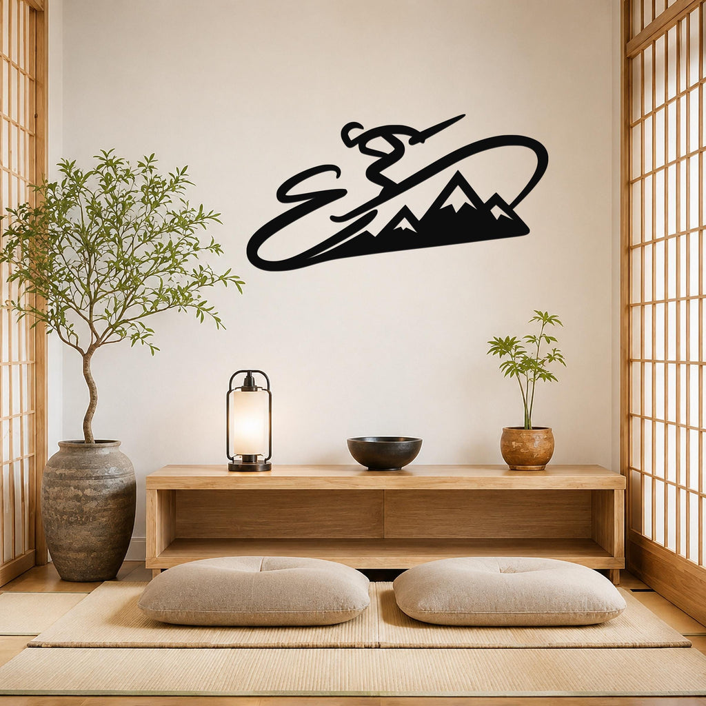 Black metal wall art silhouette of a skier in motion above a mountain range, mounted on a light-colored wall above a wooden console in a minimalist room.