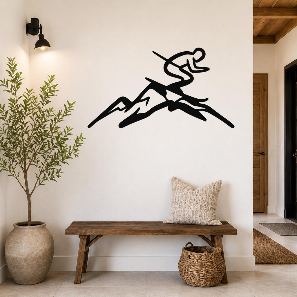 Black metal wall art silhouette of a skier in motion above a wooden bench in a hallway.