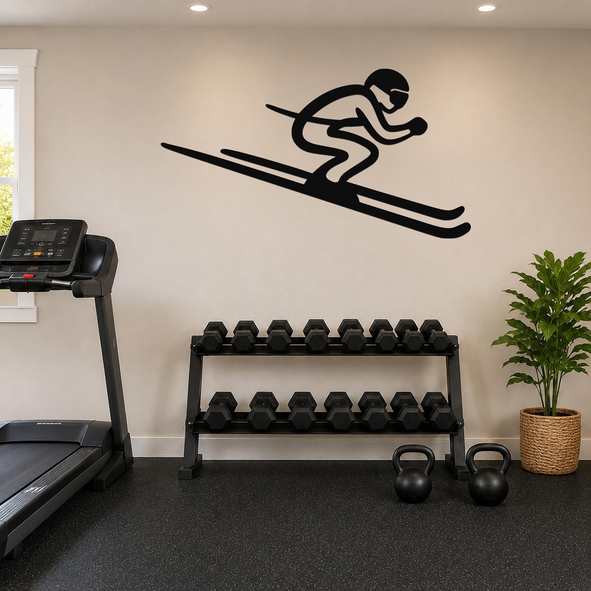 Black metal skier silhouette wall art with extended skis, mounted on a beige wall above a dumbbell rack in a home gym.