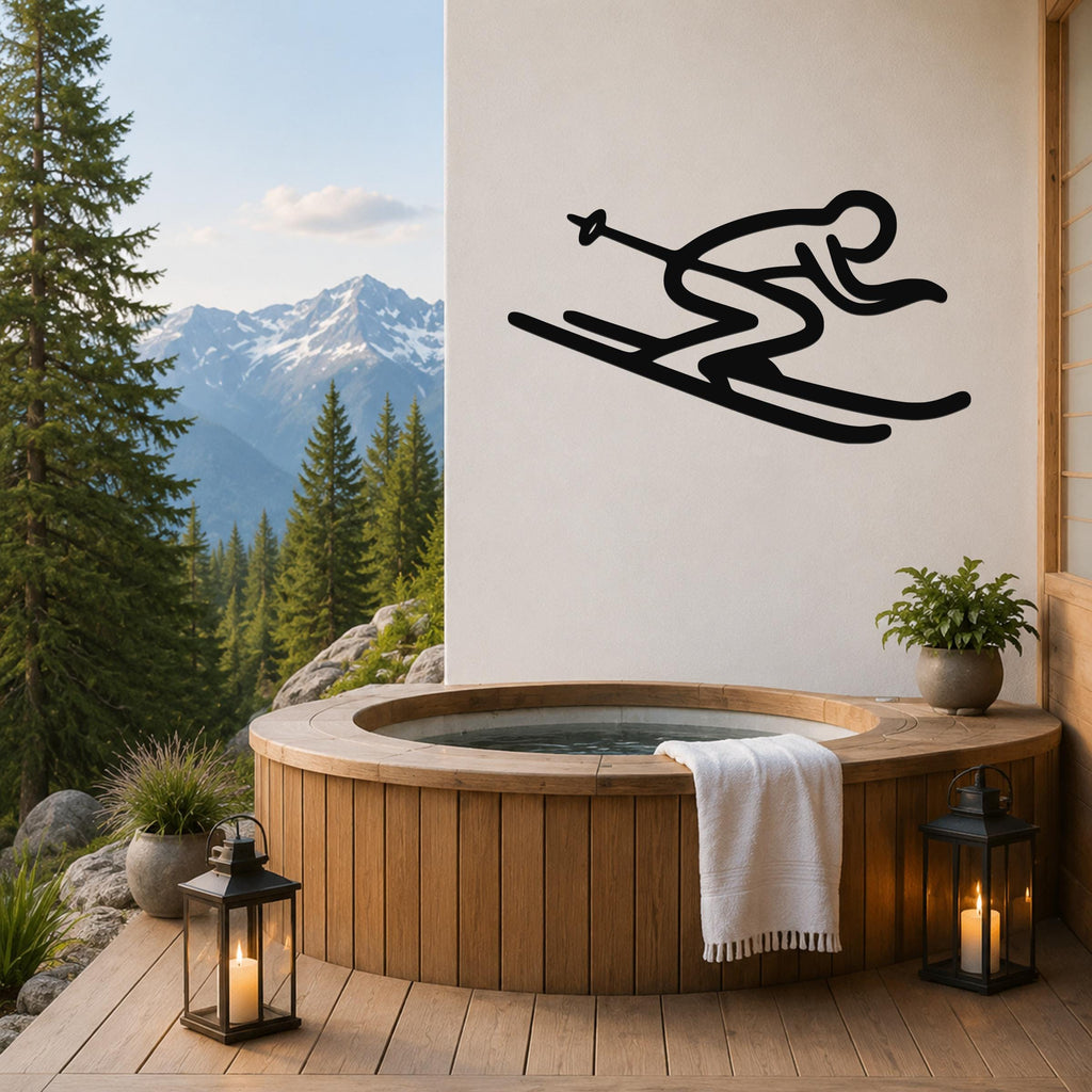 Black metal skiing wall art with a minimalist silhouette of a skier in motion, mounted on a white wall above a wooden hot tub on a mountain-view deck.