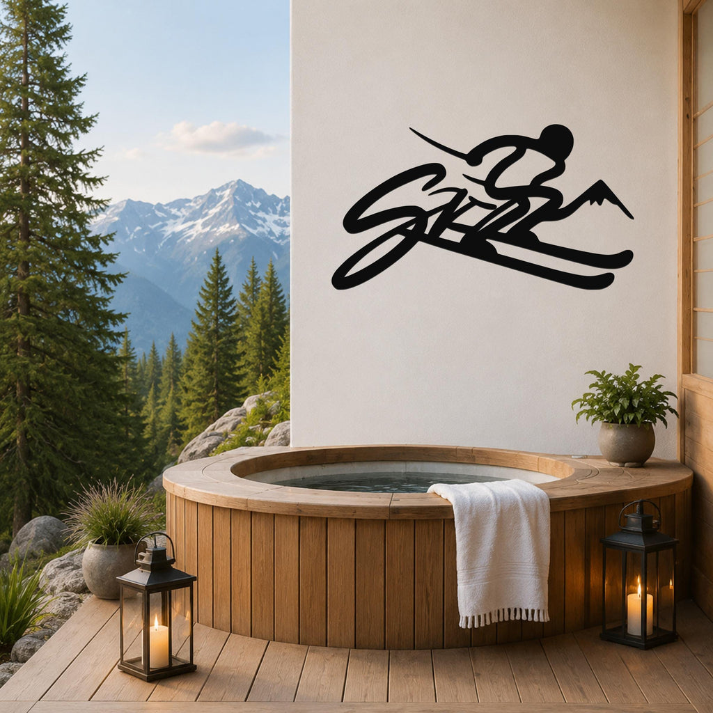 Black metal skiing wall art with a silhouette of a skier and mountain peaks, mounted on a white wall above a wooden hot tub on a mountain-view deck.