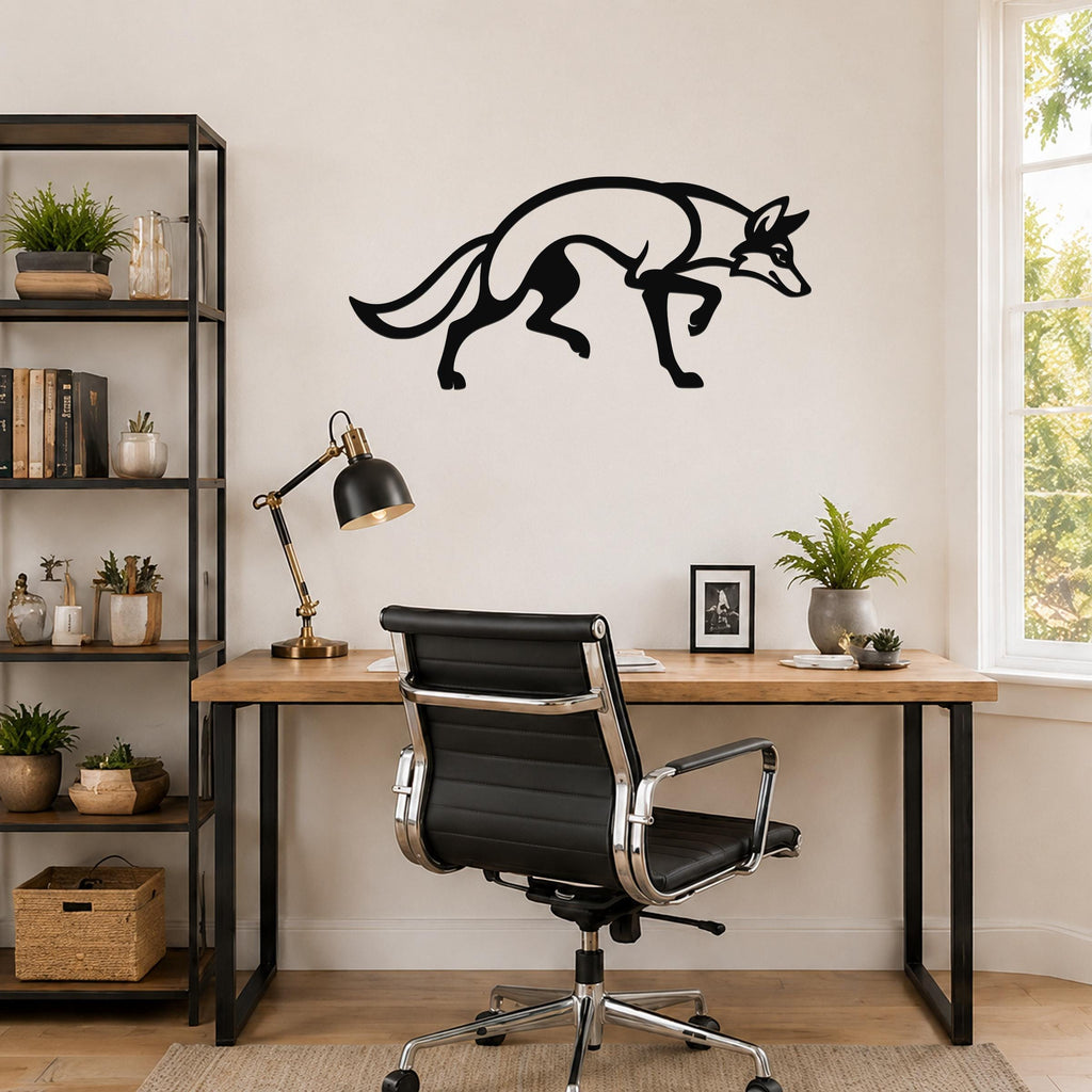 Black metal coyote wall art with a sleek silhouette design, mounted on a wall above a wooden desk in a modern home office.
