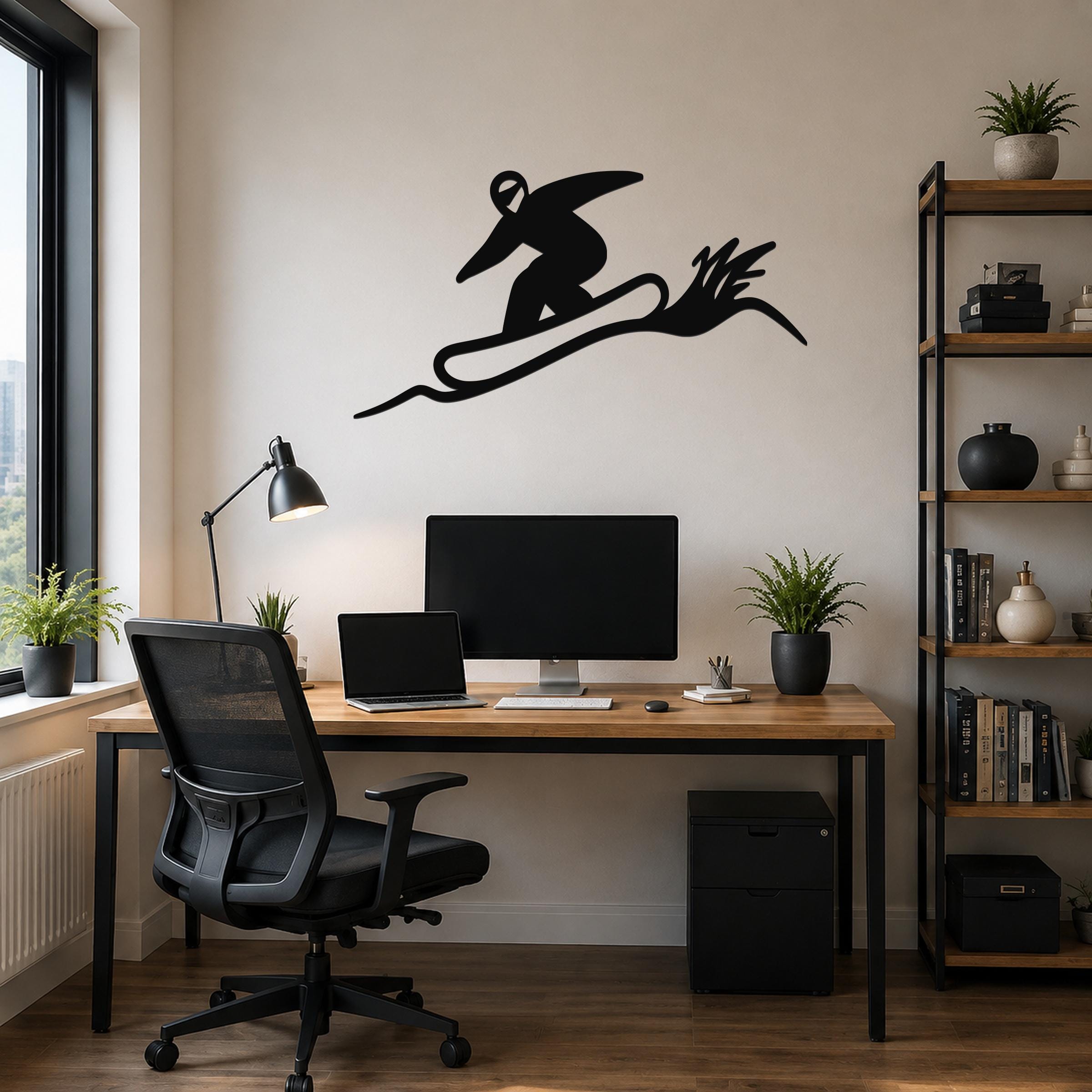 Black metal snowboarder wall sculpture with motion-line cutouts, mounted above a wooden desk in a modern home office.