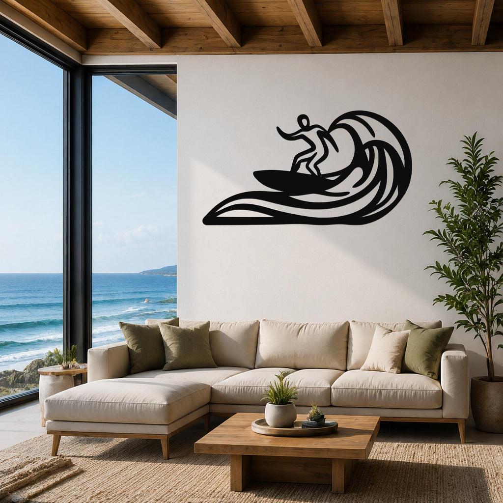 Black metal surfer wall art with wave cutouts, mounted above a beige sectional sofa in a living room with ocean views.