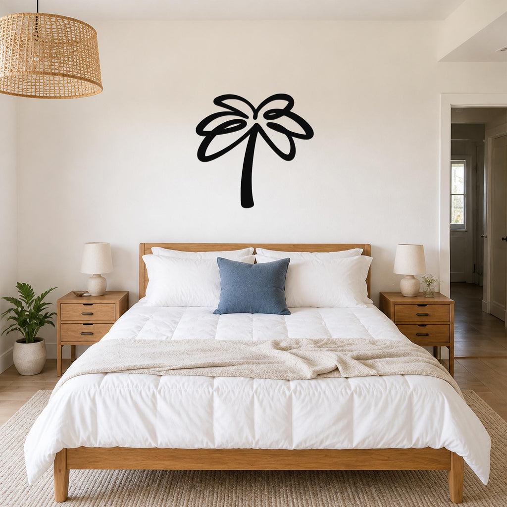Black metal palm tree wall art with flowing frond cutouts, mounted above a wooden bed in a bright bedroom.