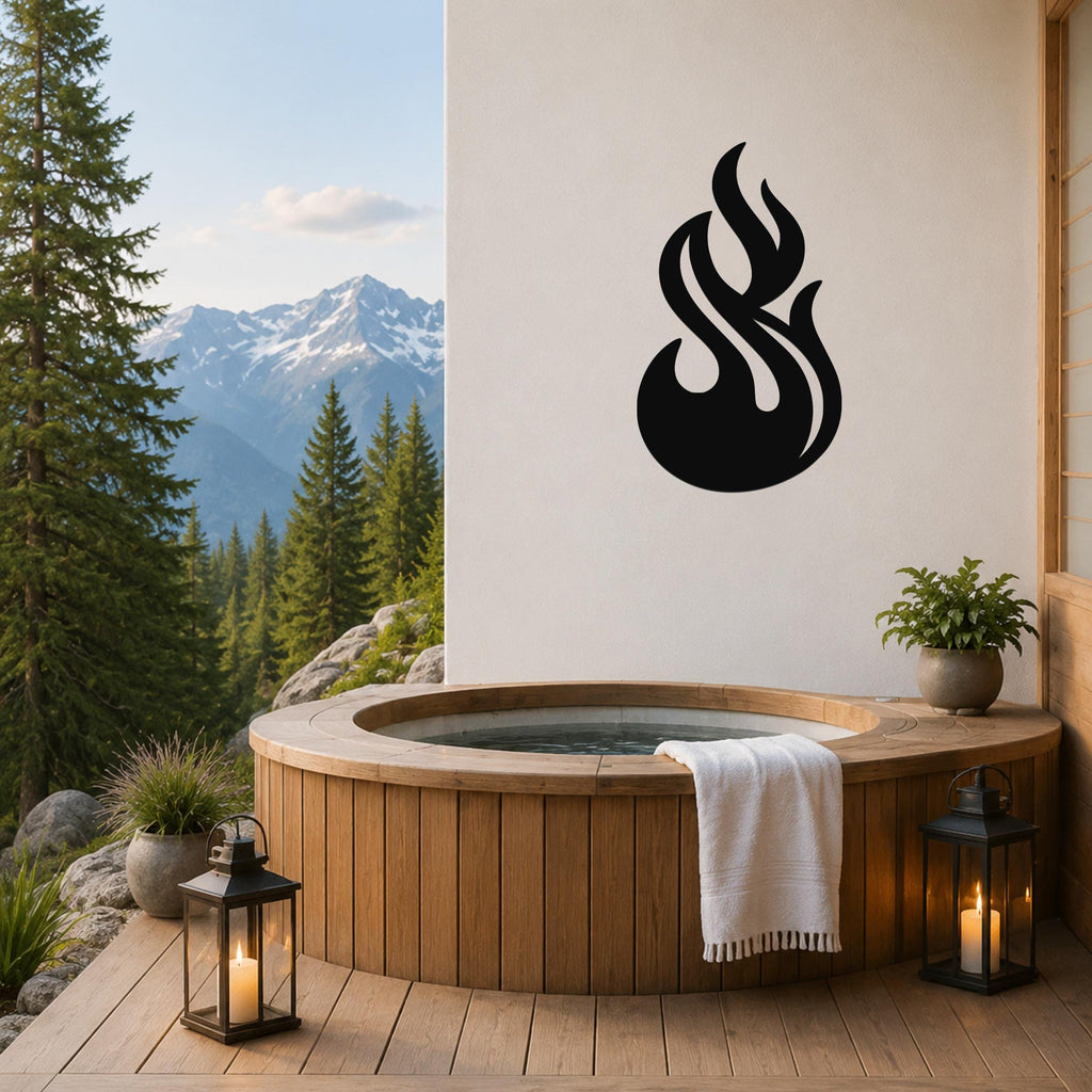Black metal flame wall art with fluid, dynamic cutouts, mounted on a white wall above a wooden hot tub on a mountain-view deck.