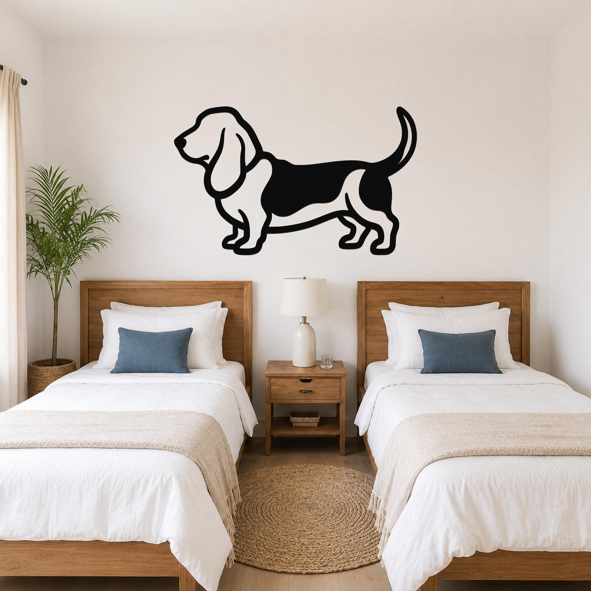 Black metal Basset Hound wall art silhouette mounted above two twin beds in a bedroom.