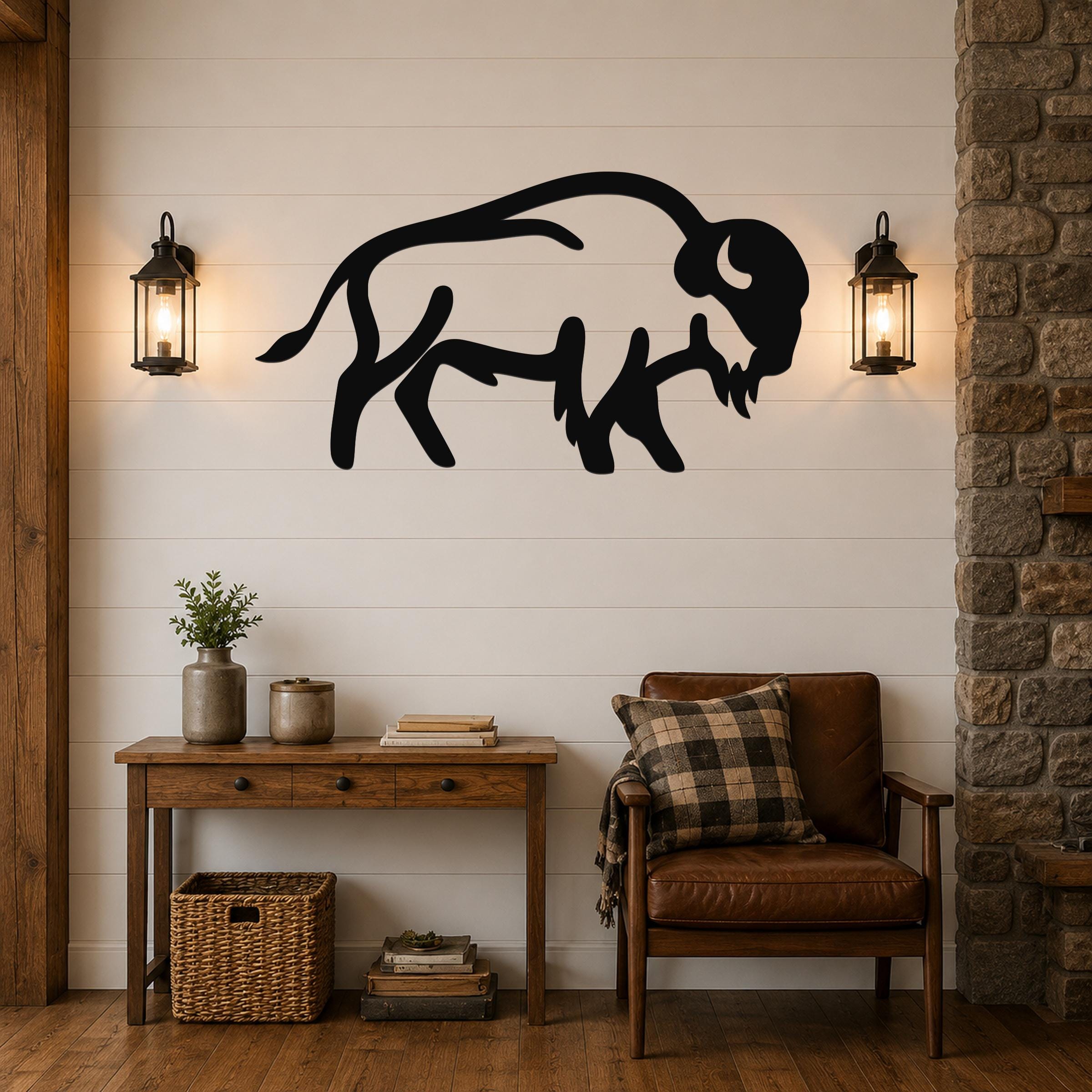 Black metal buffalo silhouette wall art mounted on a white shiplap wall above a wooden console table in a rustic living room.