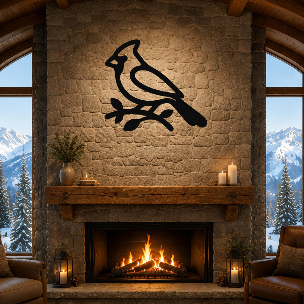 Black metal cardinal wall art silhouette perched on a branch, mounted above a stone fireplace in a rustic living room.