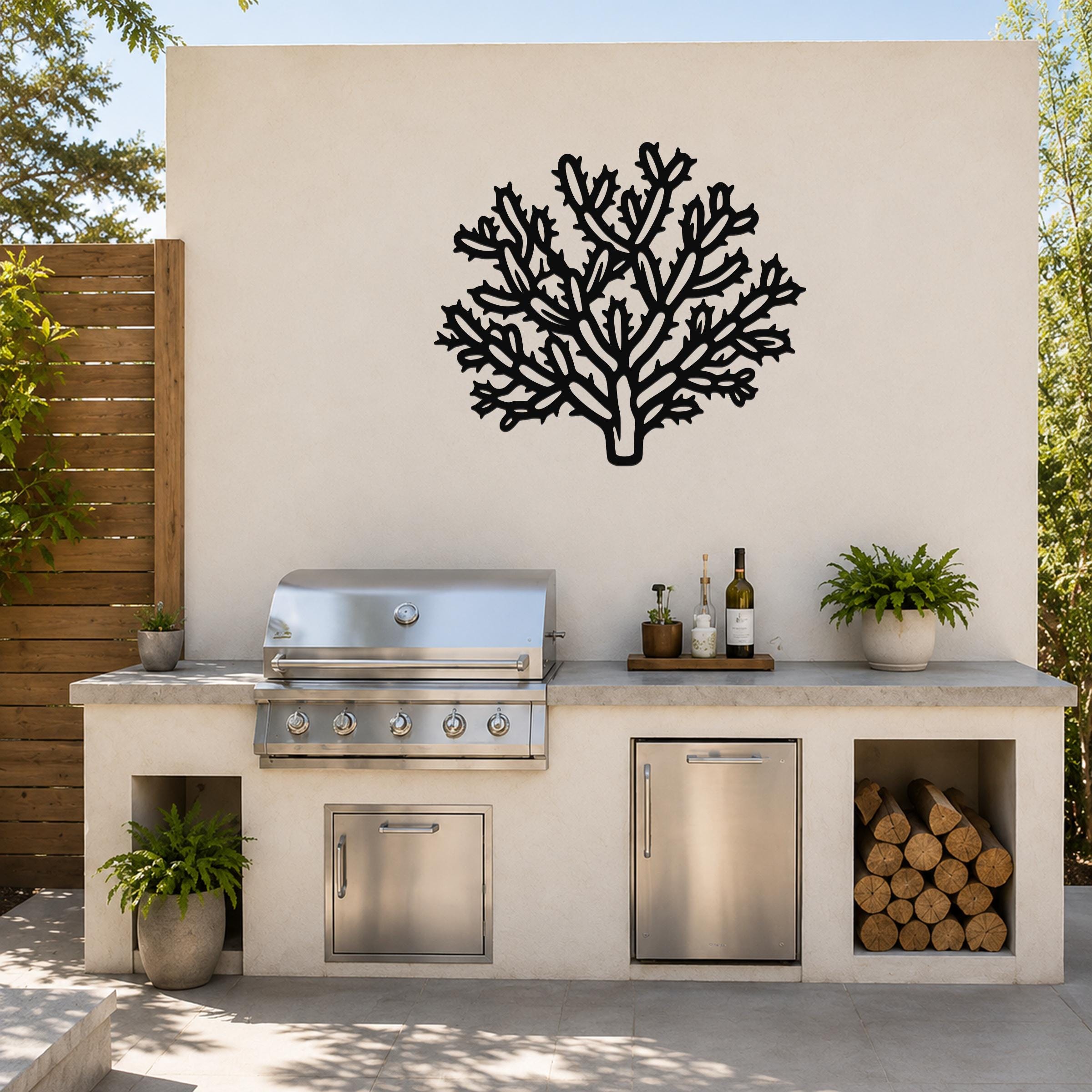 Black metal Cholla cactus wall art with intricate branch cutouts, mounted on a light-colored outdoor wall above a kitchen counter.