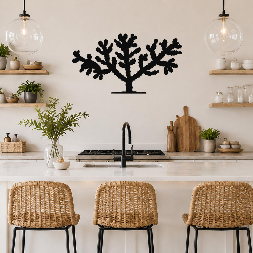 Black metal Cholla cactus wall art silhouette with branching cutouts, mounted on a kitchen wall above a counter.