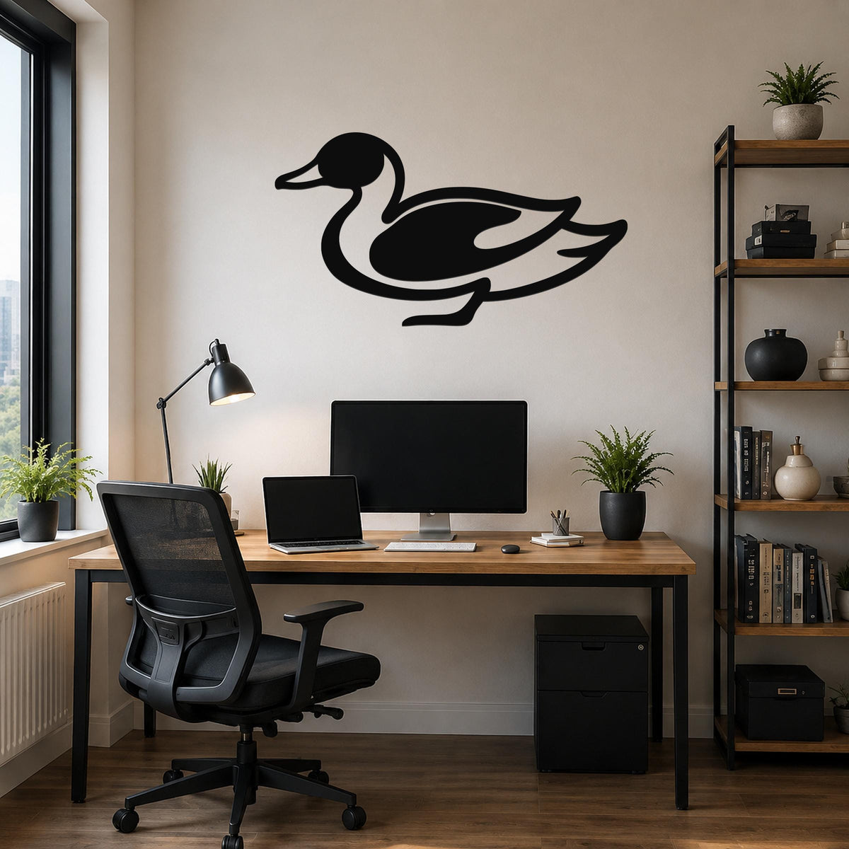 Black metal duck wall sculpture with a cutout silhouette, mounted above a wooden desk in a modern home office.