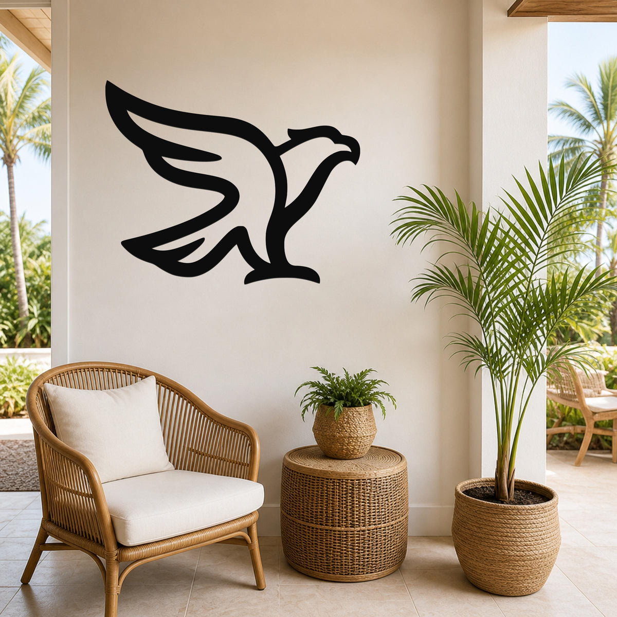 Black metal eagle wall art with a bold silhouette design, mounted on a light-colored wall above a wicker chair and potted plants in a bright indoor-outdoor space.