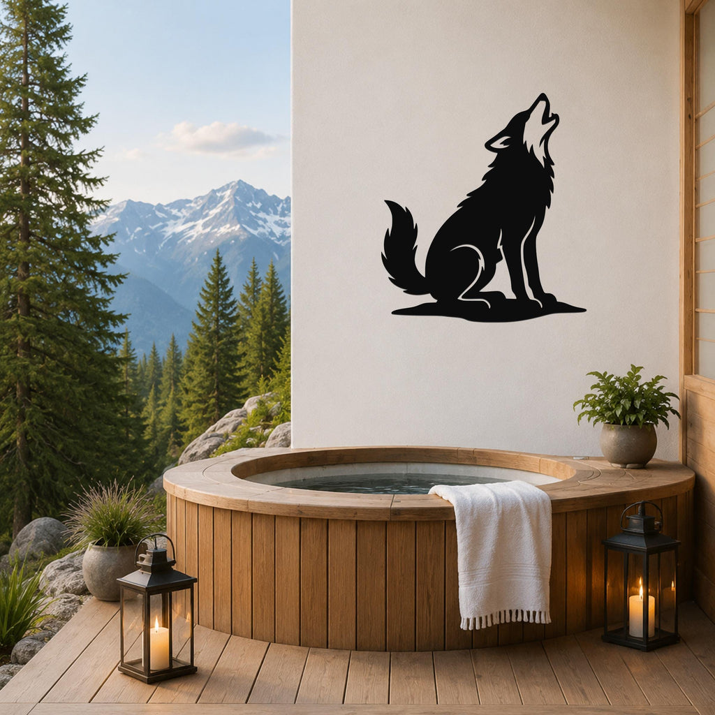 Black metal coyote wall art in a howling silhouette, mounted on a white wall above a wooden hot tub on a mountain-view deck.