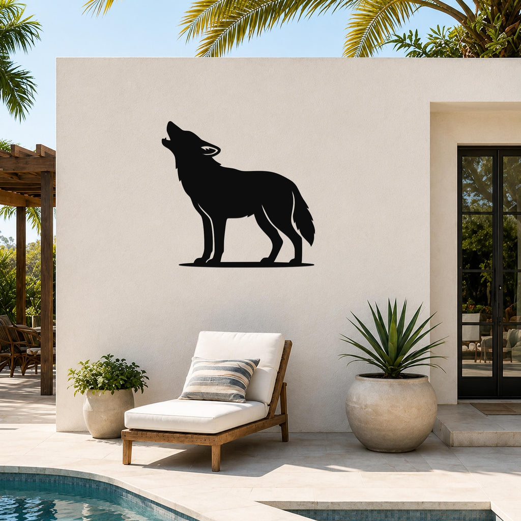 Black metal coyote wall art in a howling silhouette, mounted on an outdoor patio wall above a lounge chair and potted plants.
