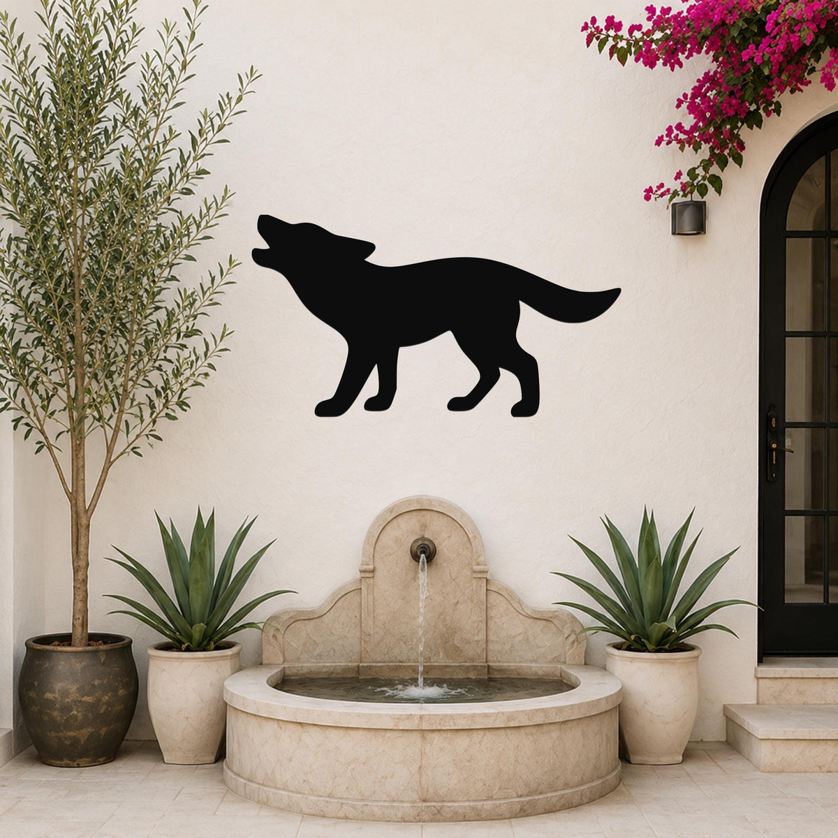 Black metal coyote wall art silhouette howling, mounted on a white outdoor wall above a stone fountain with potted plants and a blooming vine.