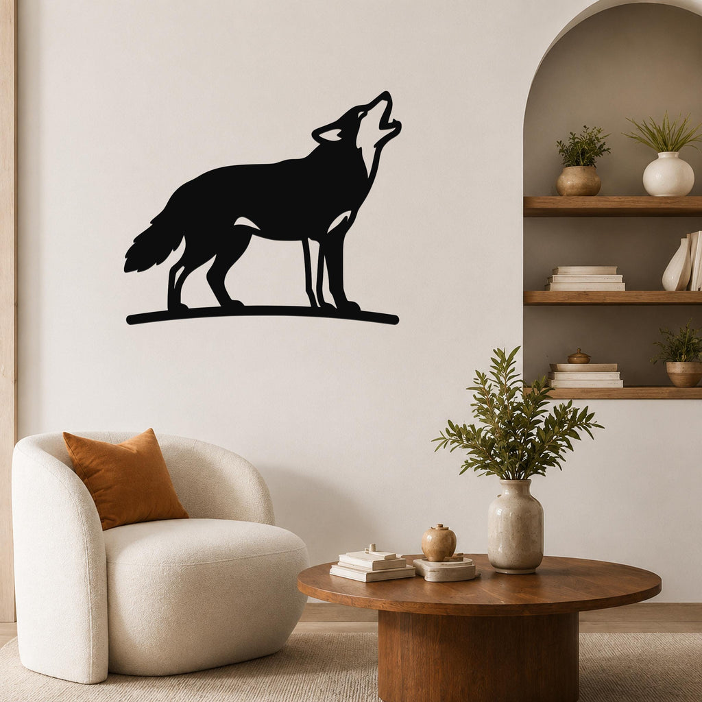 Black metal coyote wall art in a howling silhouette, mounted on a living room wall above a white armchair.