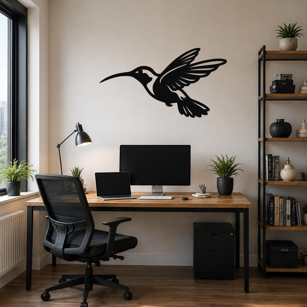Black metal hummingbird wall art with an airy silhouette design, mounted above a wooden desk in a modern home office.