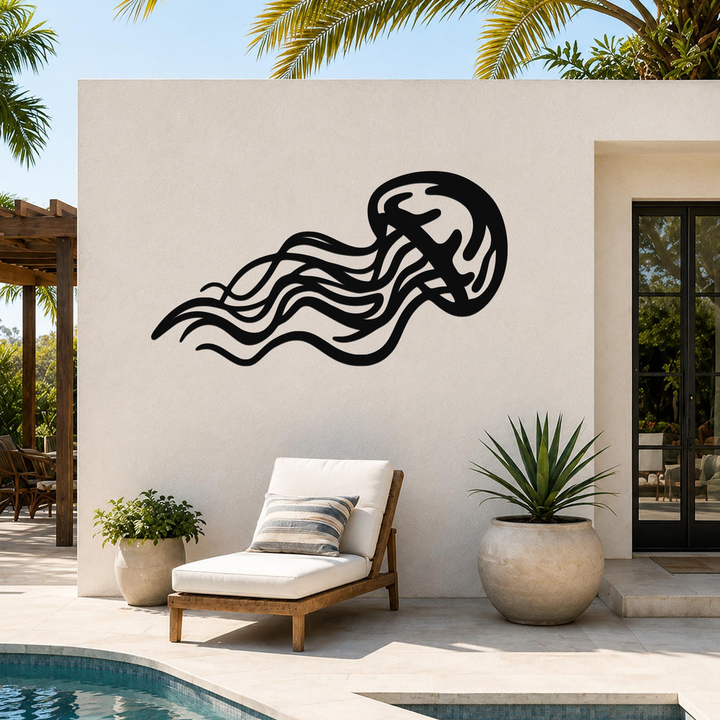Black metal jellyfish wall art with flowing tentacle cutouts, mounted on an outdoor patio wall above a lounge chair.