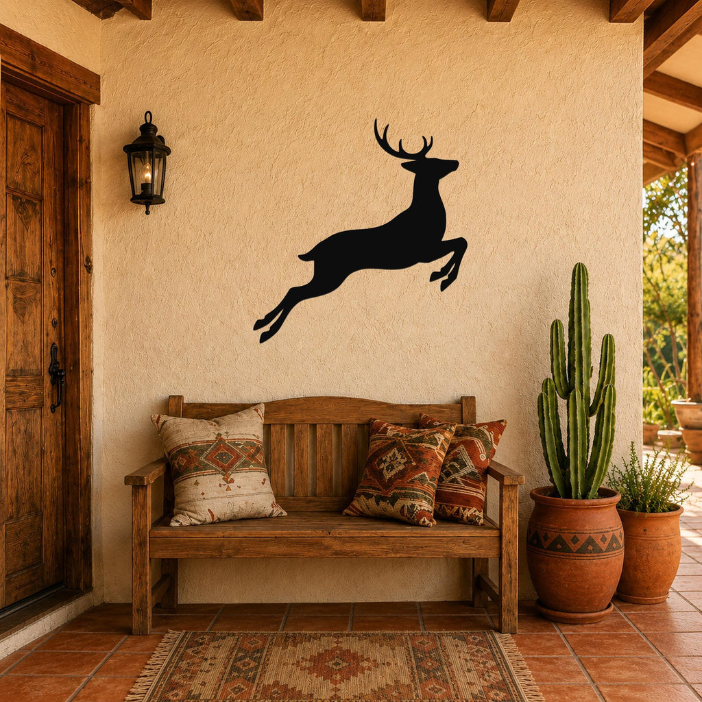 Black metal jumping deer wall art silhouette mounted on a stucco wall above a wooden bench in a rustic patio entryway.