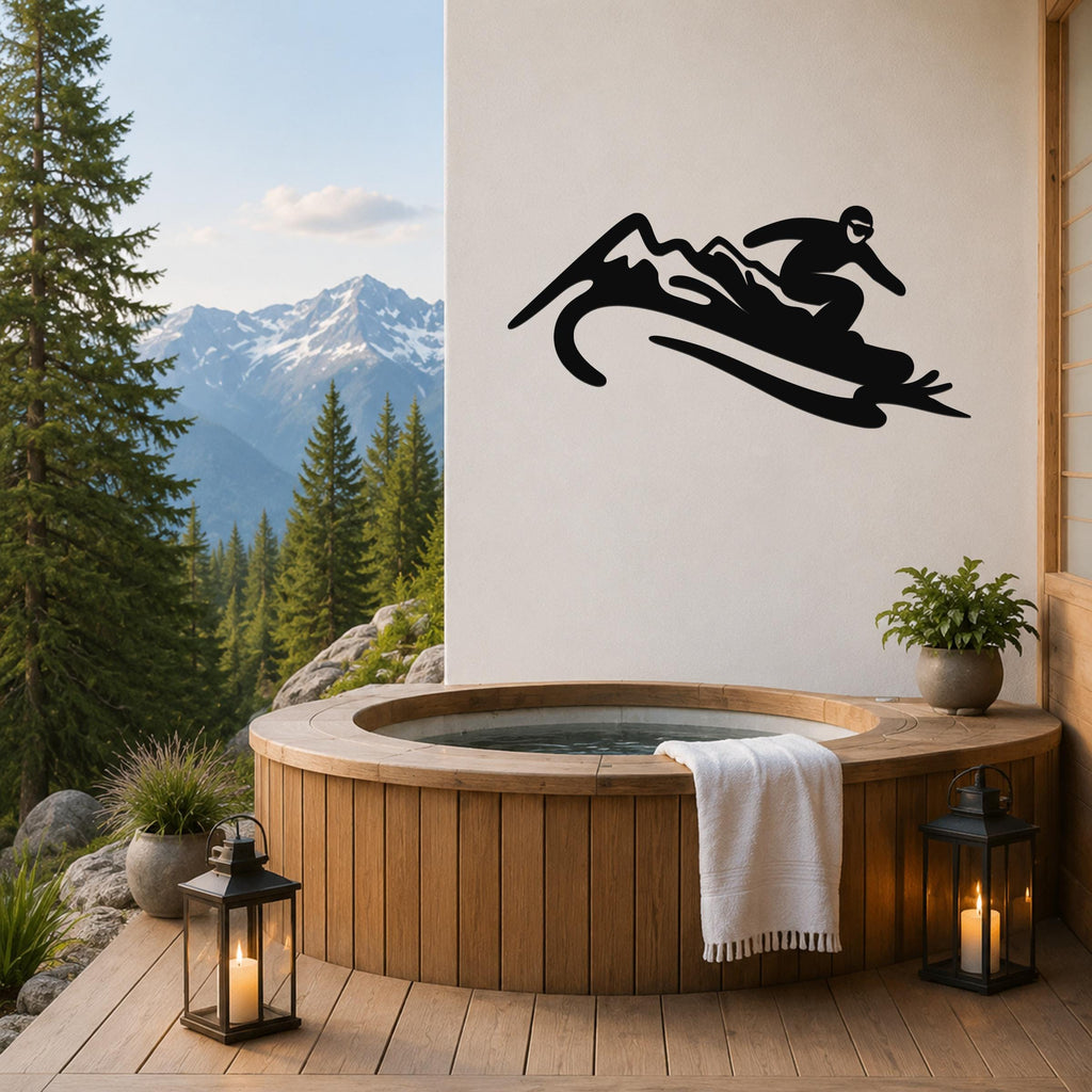 Black metal wall art silhouette of a snowboarder in motion, mounted on a white wall above a wooden hot tub on a mountain-view deck.
