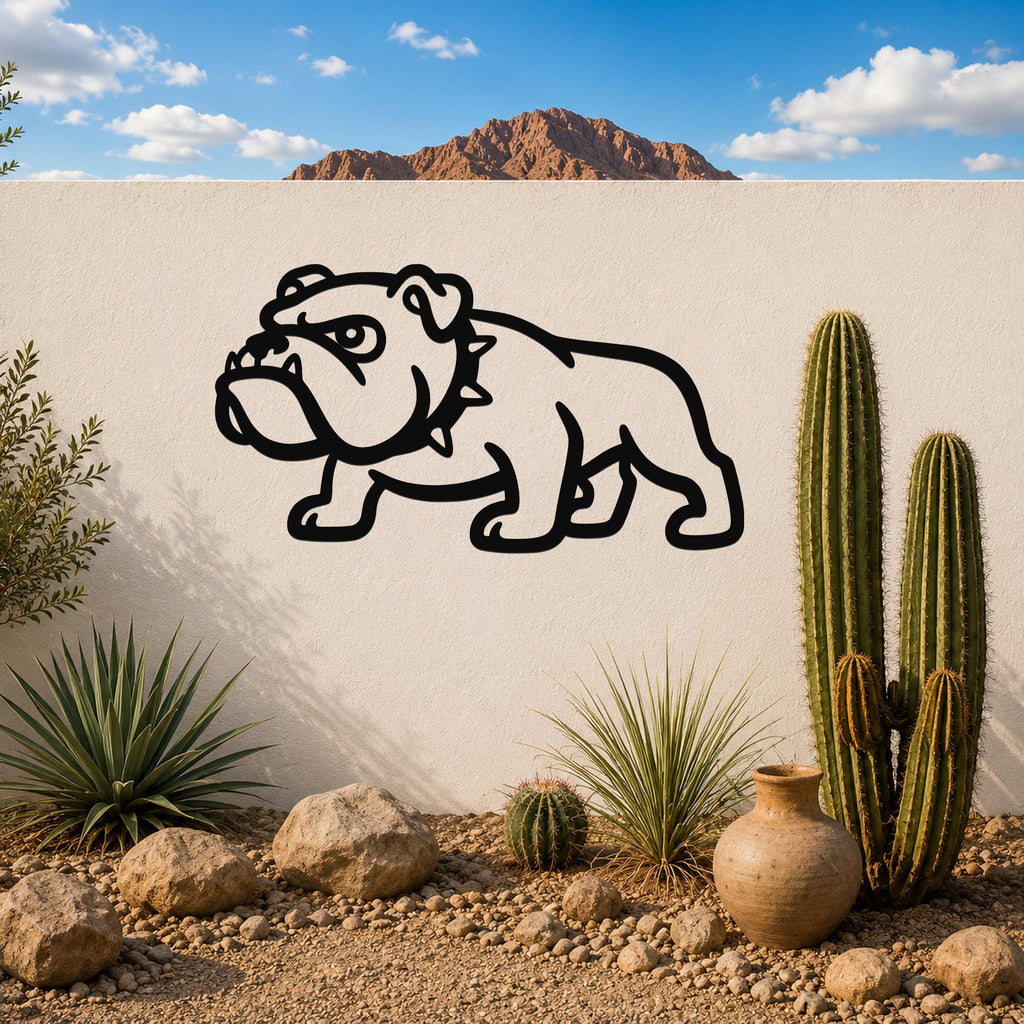 Black metal bulldog wall sculpture with bold silhouette cutout, mounted on a white outdoor wall above a desert garden with cacti and rocks.