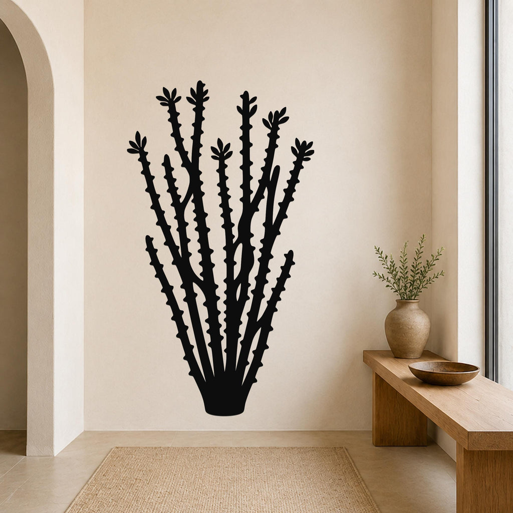 Black metal ocotillo wall art with spiky branch cutouts, mounted on a beige wall above a wooden bench in a neutral entryway.