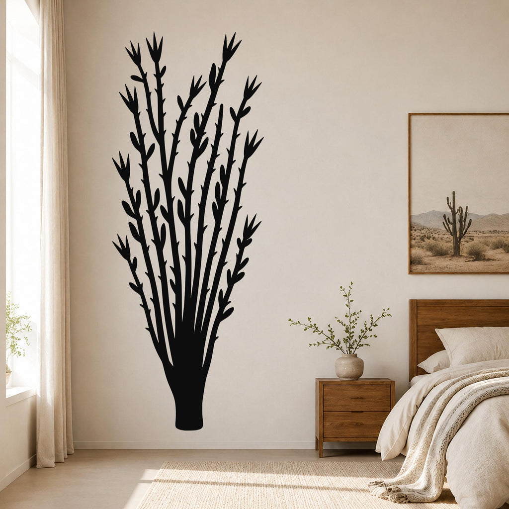 Black metal ocotillo wall art with branching silhouette, mounted on a bedroom wall above a nightstand.
