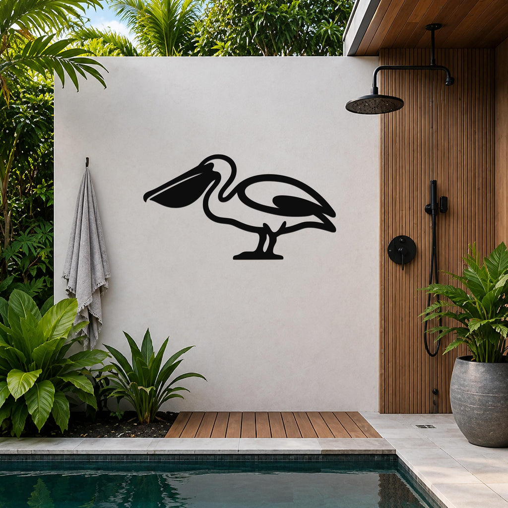Black metal pelican wall art silhouette mounted on a light-colored outdoor wall beside a wooden shower enclosure and pool.