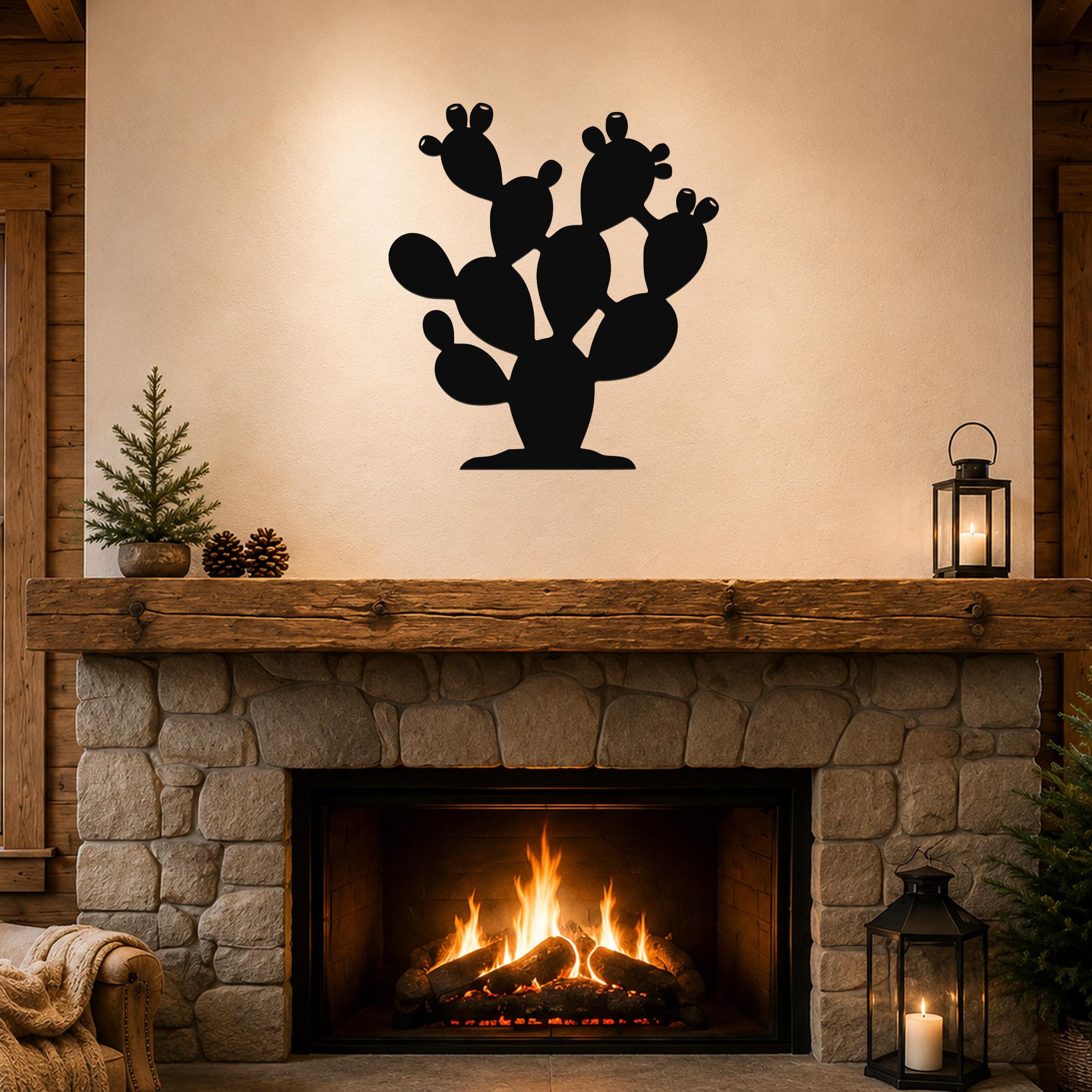 Black metal prickly pear cactus wall art with multiple paddle-shaped segments and cutout details, mounted above a stone fireplace in a rustic living room.