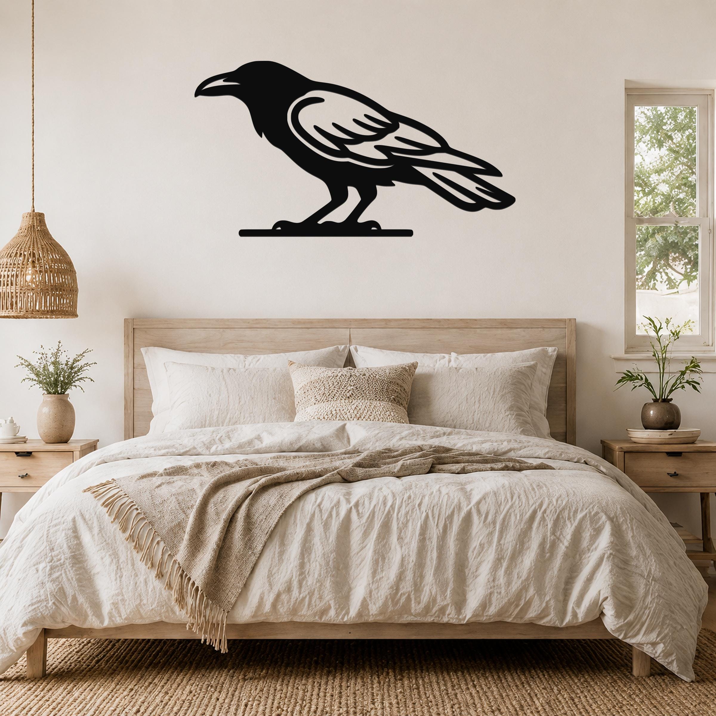 Black metal raven wall art silhouette mounted above a bed in a neutral bedroom.