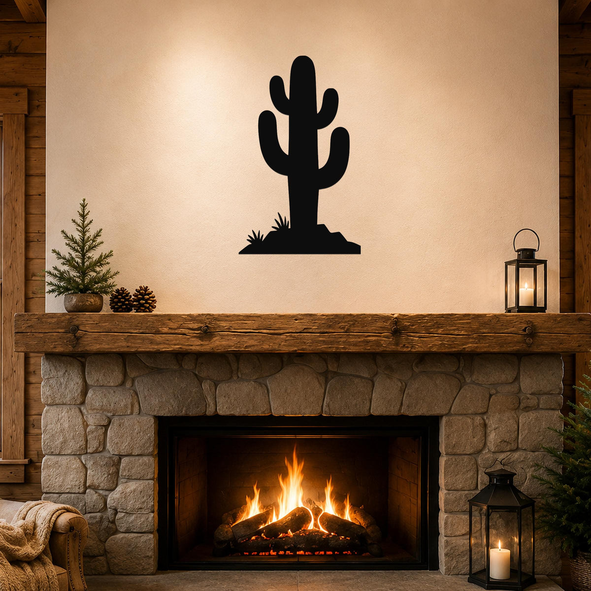 Black metal saguaro cactus wall art with a silhouette design, mounted above a stone fireplace in a rustic living room.