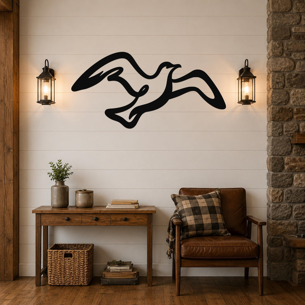 Black metal seagull wall art with flowing wing cutouts, mounted on a shiplap wall above a wooden console table in a living room.