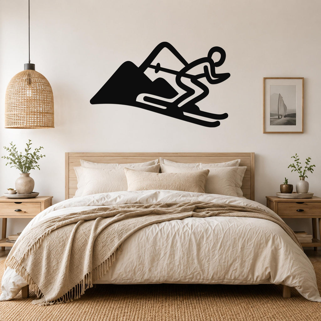 Black metal wall art featuring a skier silhouette in motion on a mountain, mounted above a bed in a bedroom.