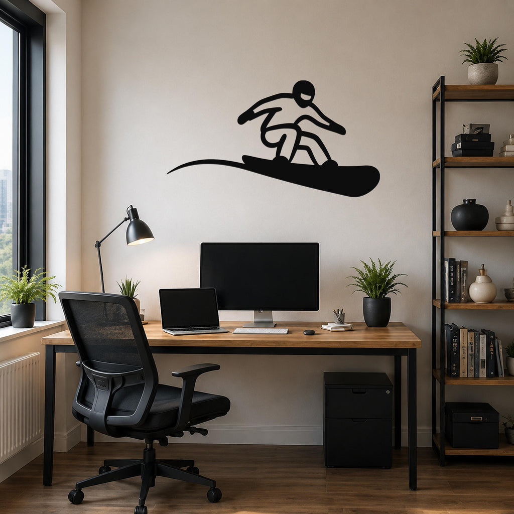 Black metal snowboarder wall art silhouette with motion-line cutout, mounted above a wooden desk in a home office.