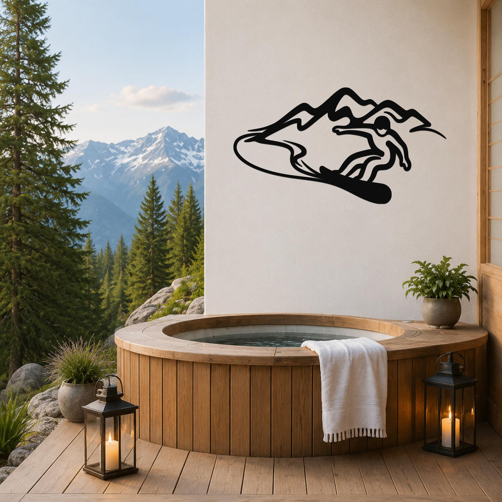 Black metal wall art silhouette of a snowboarder in motion above a mountain, mounted on a white wall above a wooden hot tub on a deck.