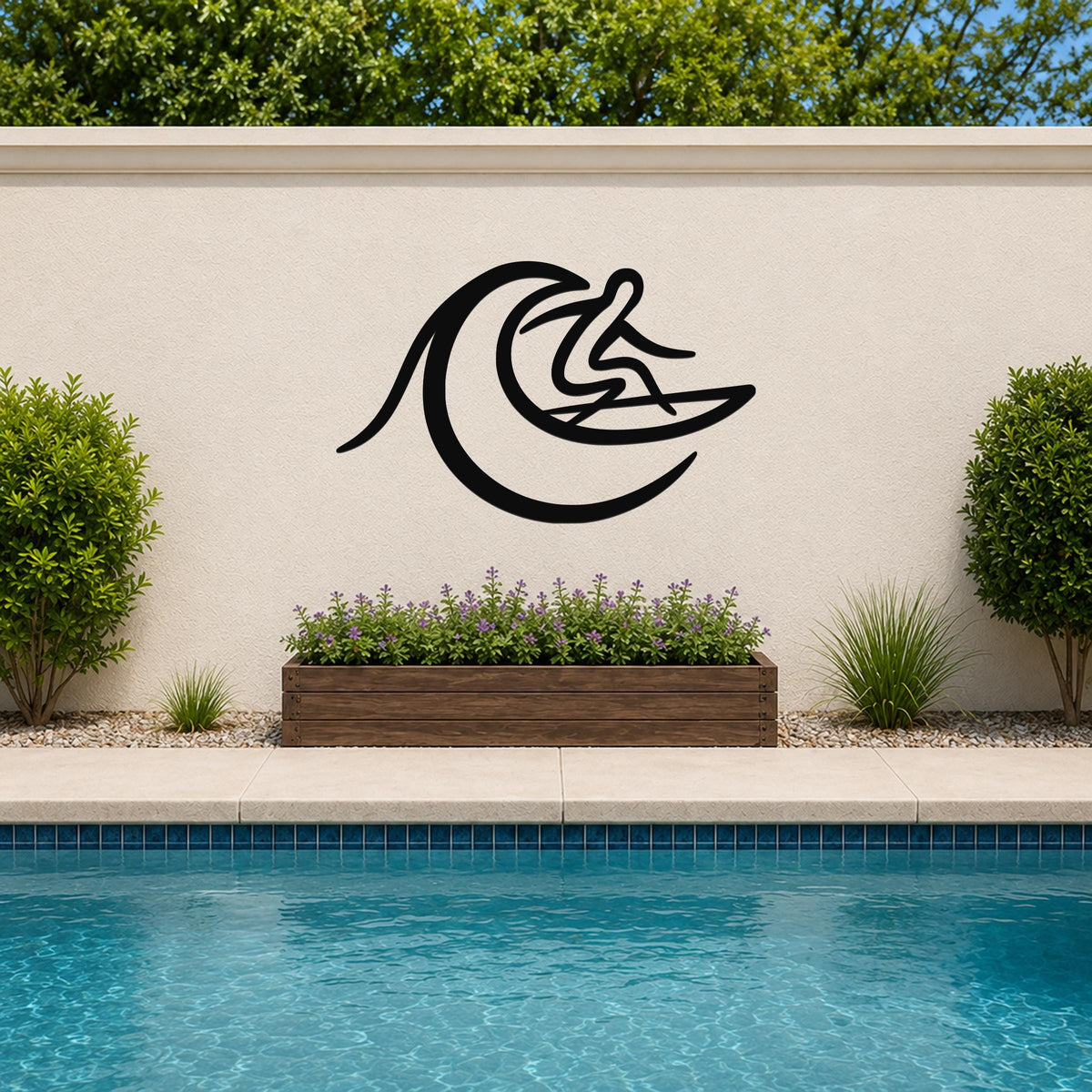 Black metal surfer wall art with wave cutout, mounted on an outdoor wall above a planter and pool.